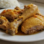 Home-cooked dorso de frango served in a white bowl on a kitchen countertop